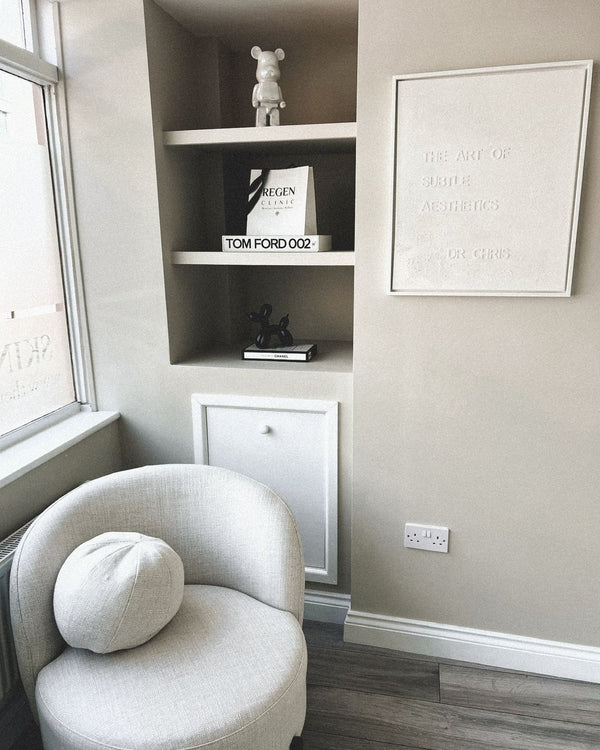 A consulting corner at REGEN Clinic, with the clinic's subtle-aesthetics artwork