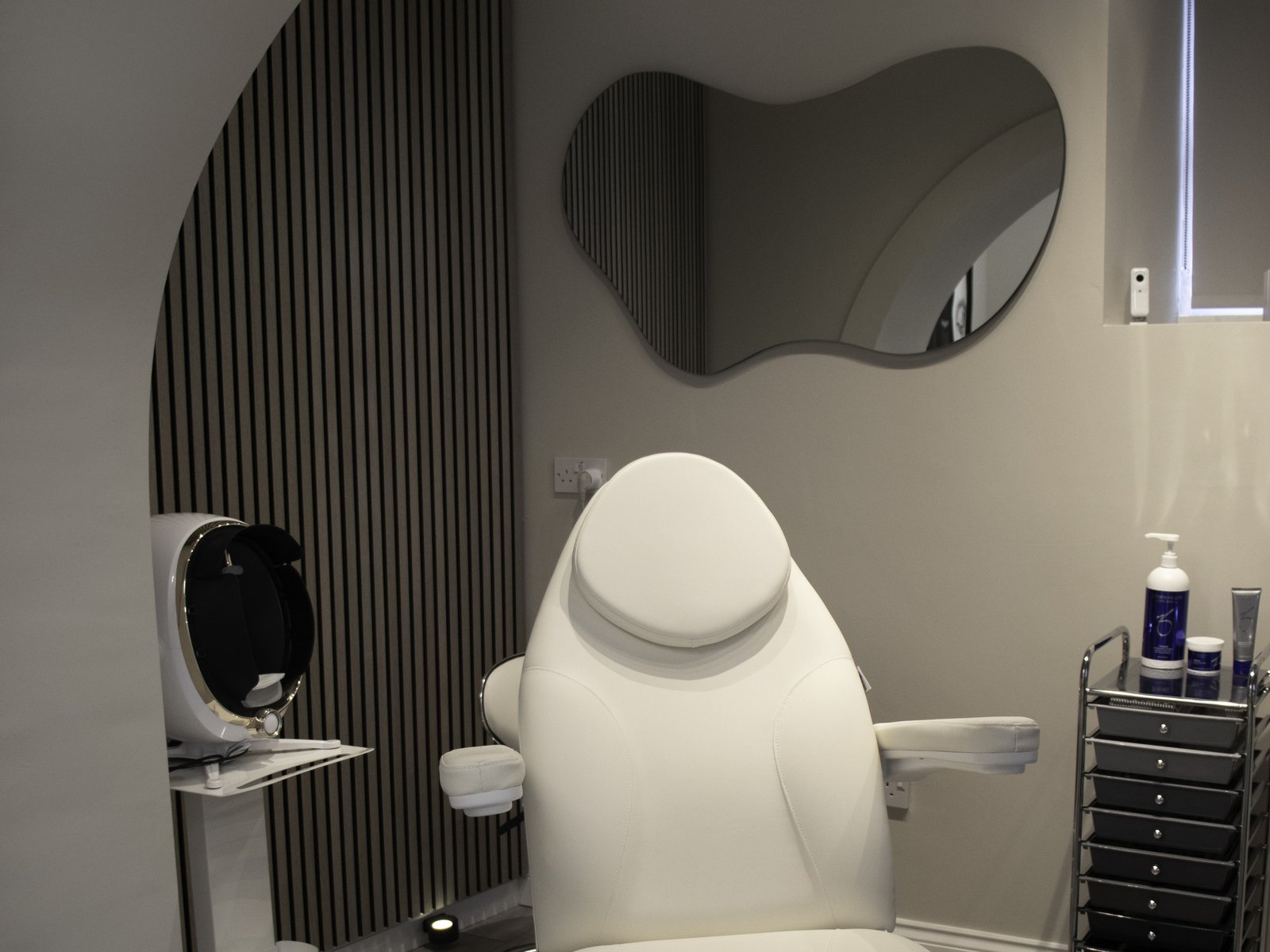 REGEN Clinic consultation room — treatment chair, organic mirror, skin analysis scanner